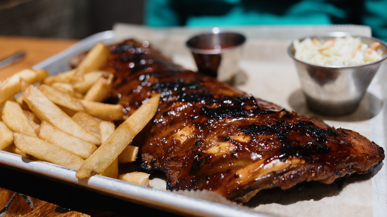 a tray of bbq ribs and fries at a restaurant