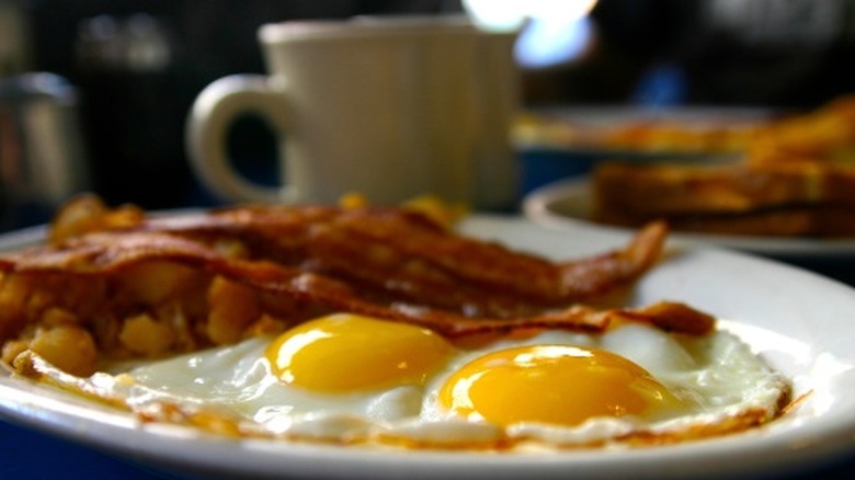 A plate of eggs and bacon served at a diner
