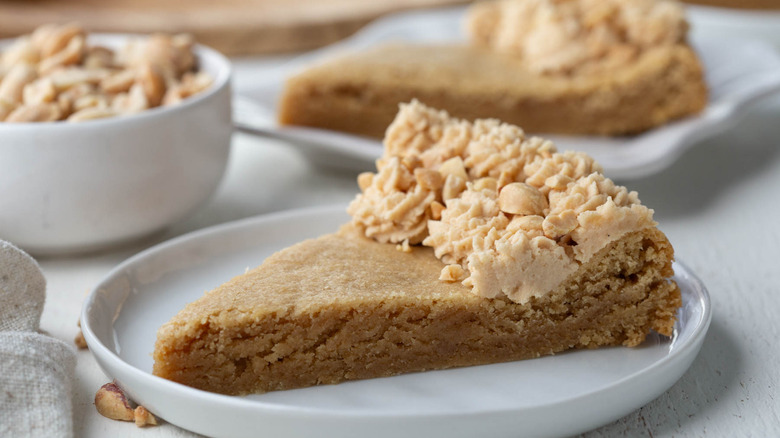 frosted peanut butter cookie cake slice on plate
