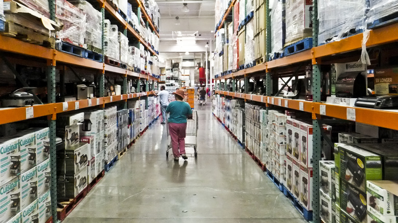 a shopper meandering down a Costco aisle