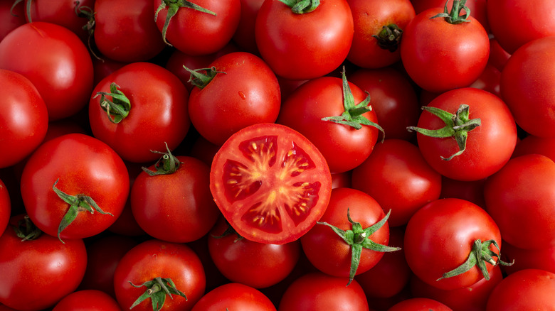 Cut red tomato close-up in a box in the market