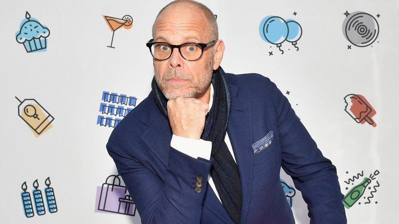 Alton Brown poses at an event.