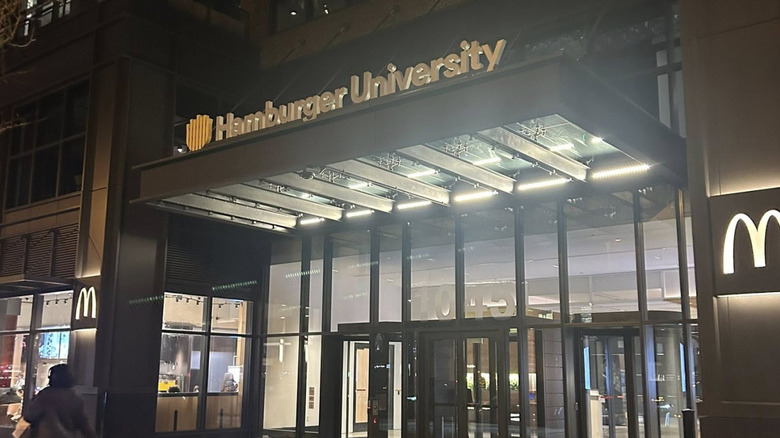 The facade of Hamburger University glows in the night.