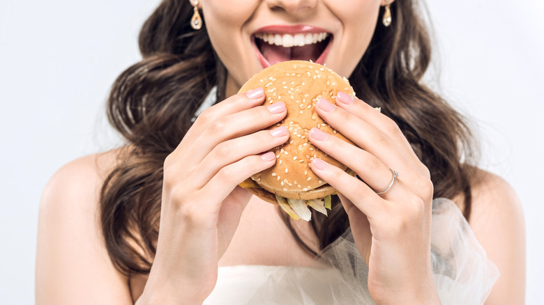 Bride eating a hamburger