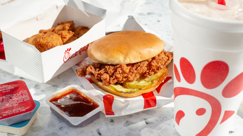 Chick-fil-A sandwich and drink with a small cup of sauce