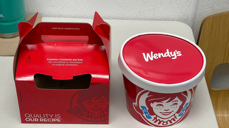 Bucket of Wendy's chili next to its red carrying box