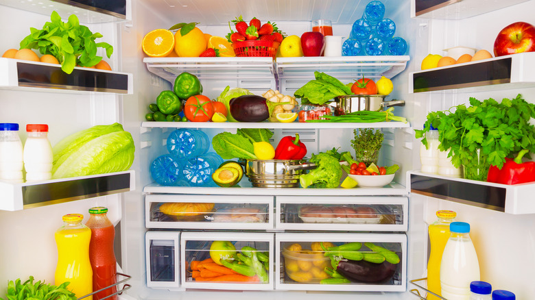 An open fridge full of fresh produce.