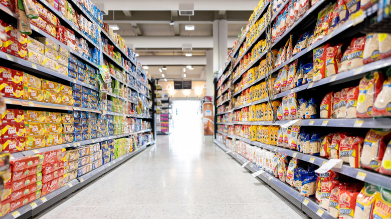 A grocery store aisle is packed with food.