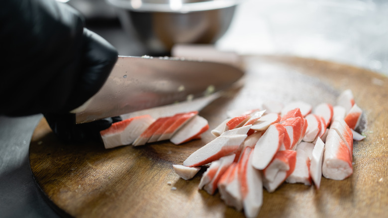slicing crab sticks on board