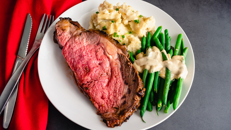 Prime rib served with mashed potatoes and asparagus