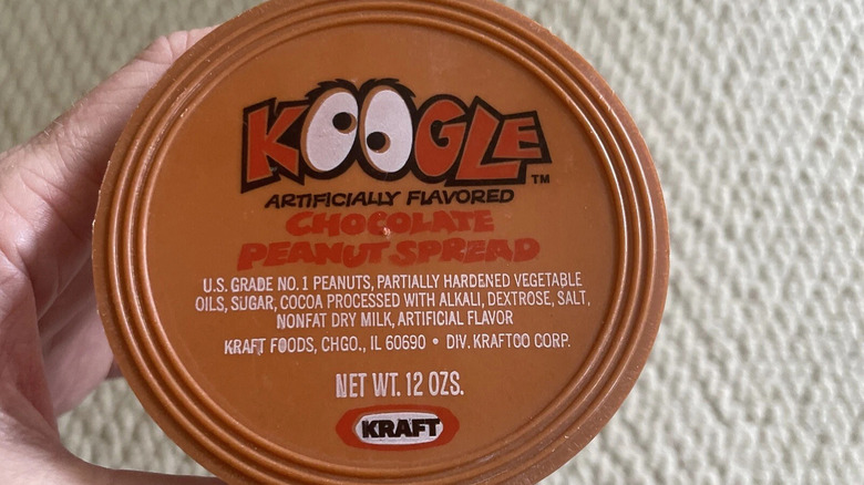 Closeup of a jar of Koogle held by a hand