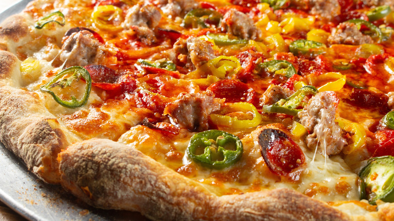 A pizza with different types of pepper on it.