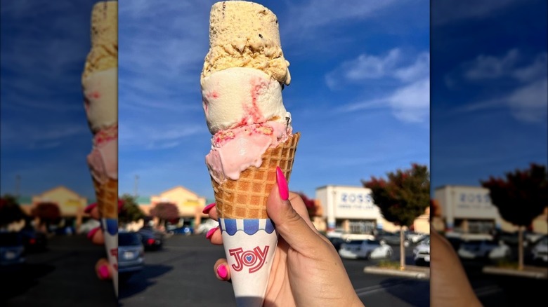 A three-scoop stack of Thrifty ice cream in a cone