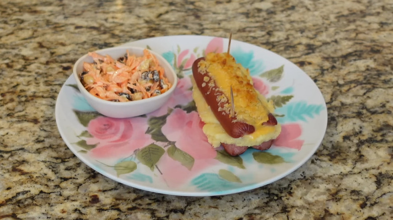 Hot dogs s'mores stuffed with mashed potatoes and topped with melted cheese