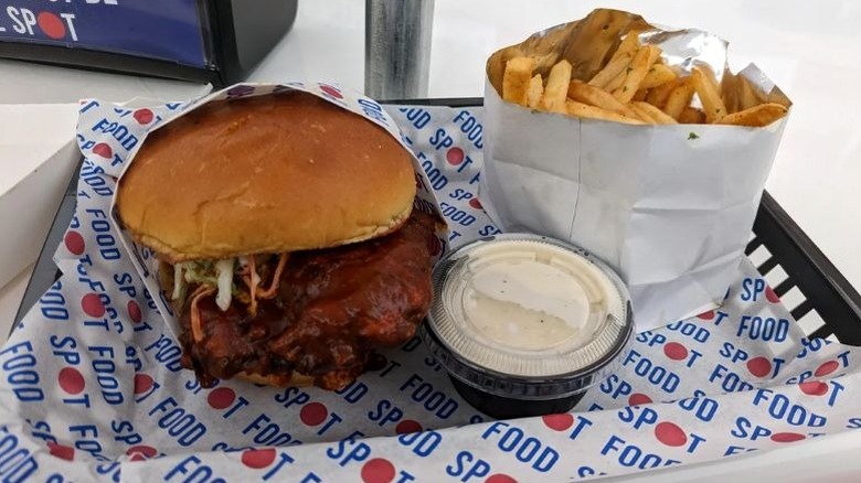 Chicken sandwich and fries with a dipping sauce from The Skechers Food Spot