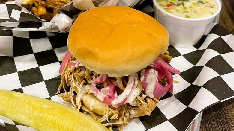 Smokin' Joe's Barbecue's Hen House sandwich with fries, queso sauce, and a pickle spear