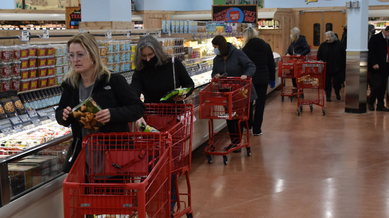 Shoppers peruse the frozen foods aisle in a Trader Joe's