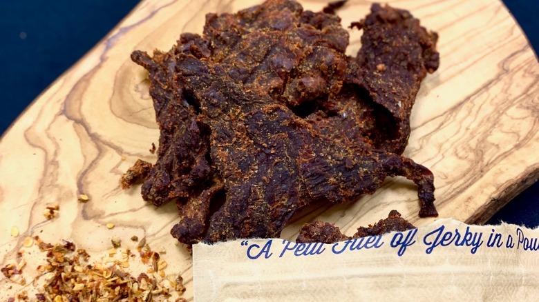 Three Jerks Jerky beef jerky on a cutting board