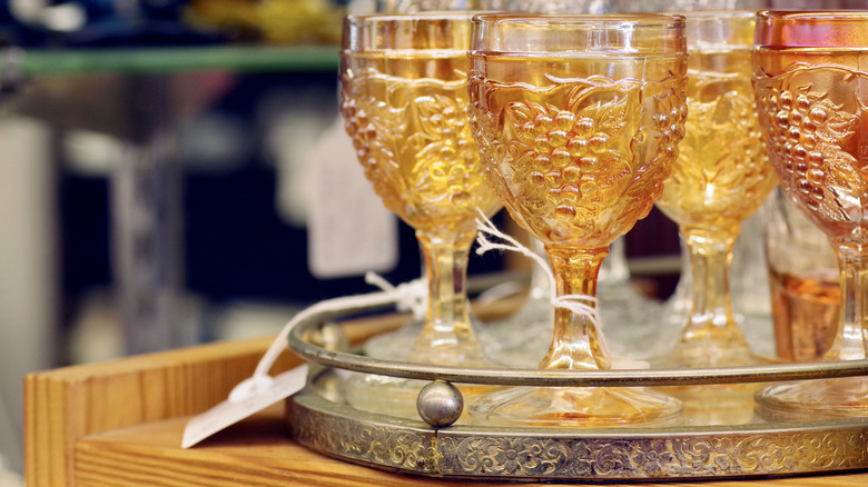 A tray of antique carnival glass cups