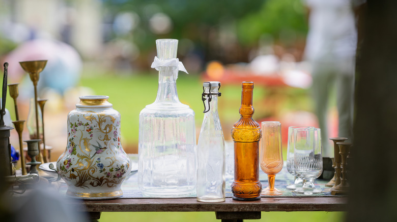 Collection of vintage glassware items at a flea market