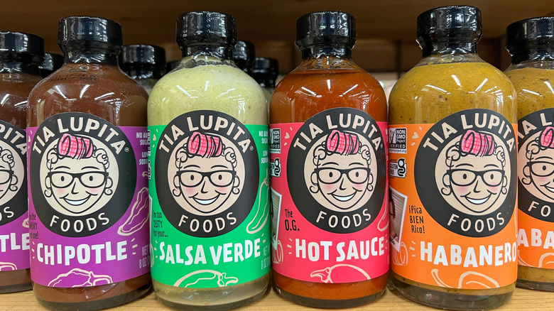 Bottles of Tia Lupita sauces on a store shelf