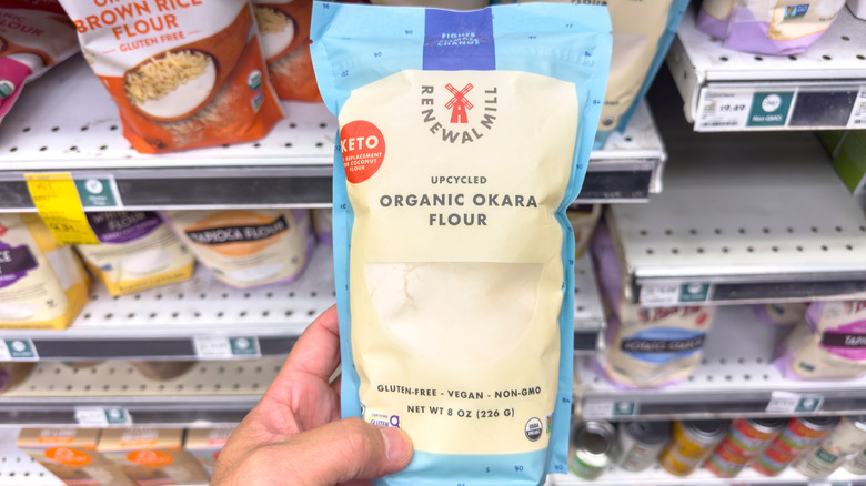 shopper holding a bag of Upcycled Organic Okara flour