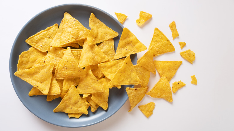 Tortilla chips spilling out of a blue bowl