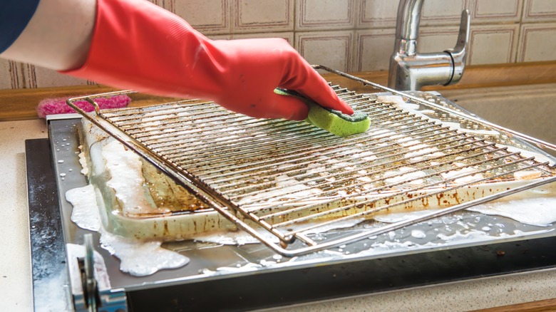 Scrubbing a dirty oven rack