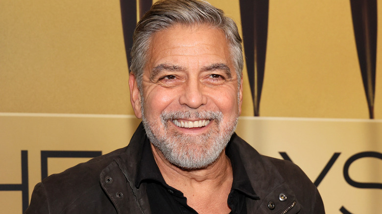 George Clooney smiling for paparazzi