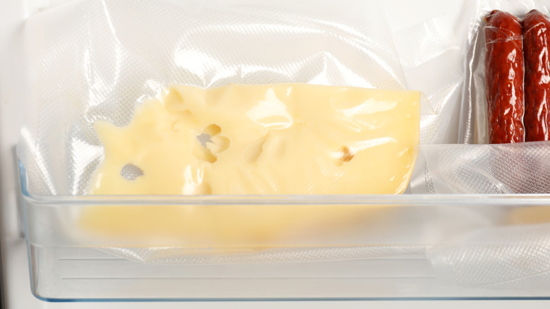 wrapped cheese next to sausages
