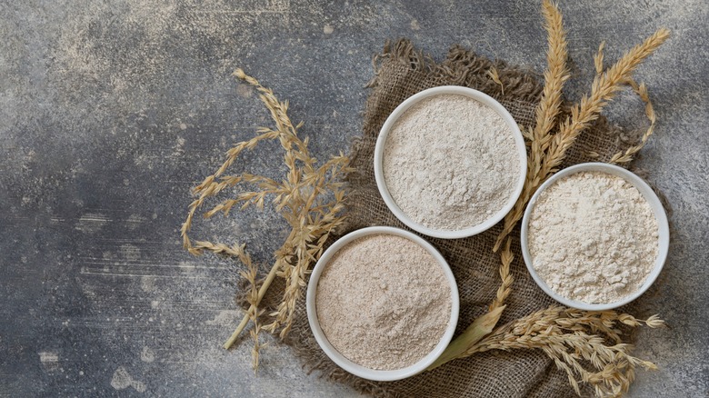 Various flours in white bowls