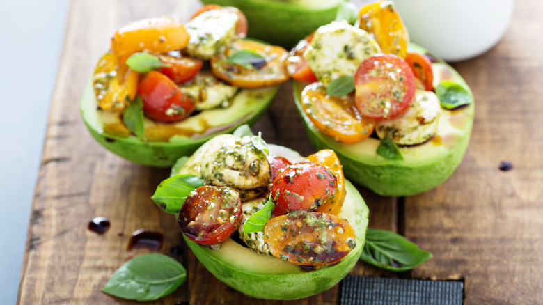 Avocado halves stuffed with caprese salad