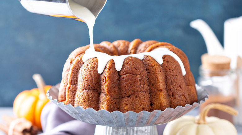 Pouring frosting over bundt cake