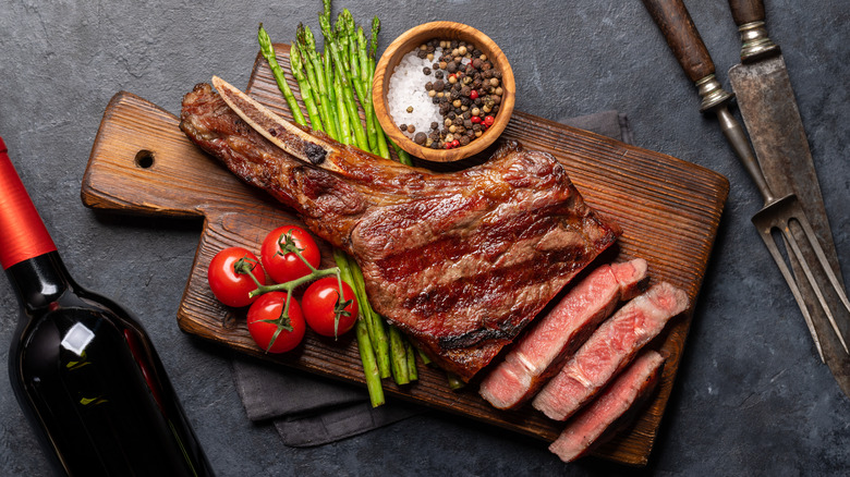 A grilled tomahawk steak with asparagus.