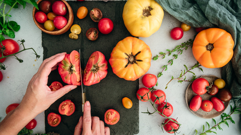 cutting different varieties of fresh tomatoes