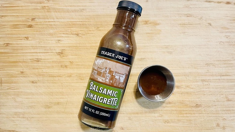 Bottle of Trader Joe's Balsamic Vinaigrette Dressing with ramekin on side