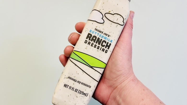 Hand holding bottle of Trader Joe's Buttermilk Ranch Dressing