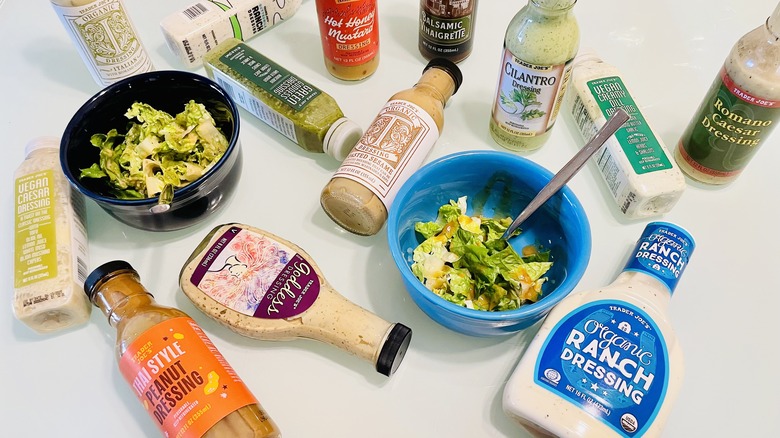 Collection of Trader Joe's salad dressings and bowl of salad