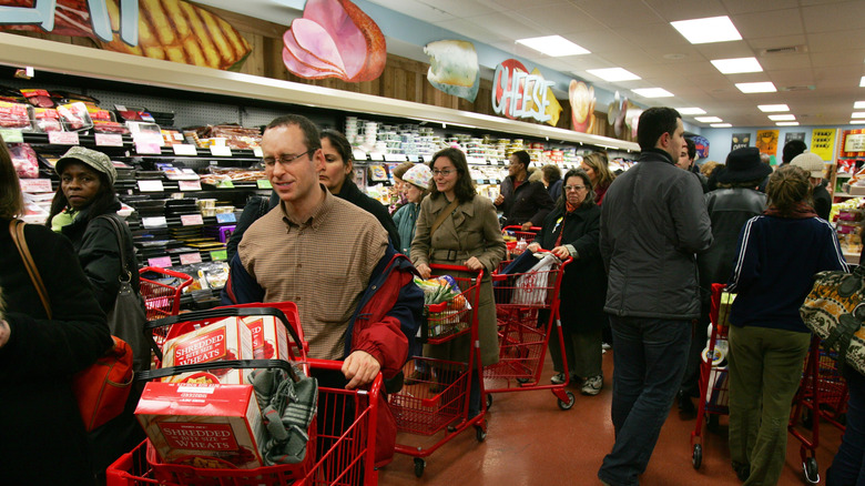 Customers push carts in a crowded aisle at Trader Joe's