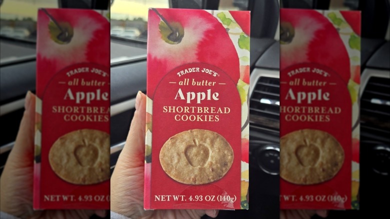 A hand holds up a container of Trader Joe's shortbread cookies