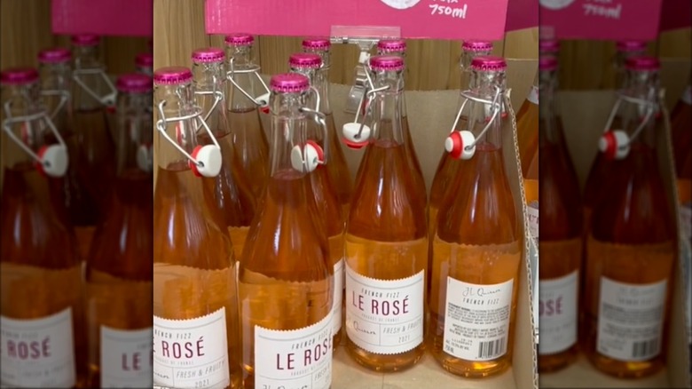Bottles of French Fizz Le Rose sit in a Trader Joe's display case