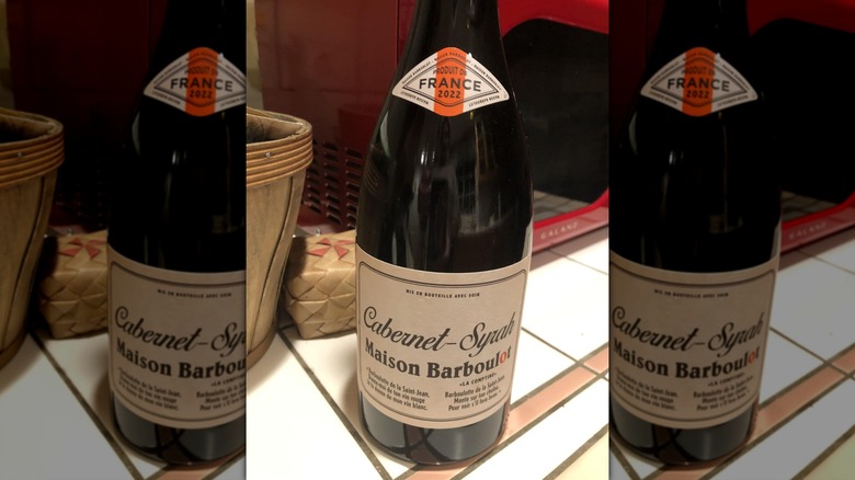 A bottle of red wine sits from Trader Joe's sits on a counter