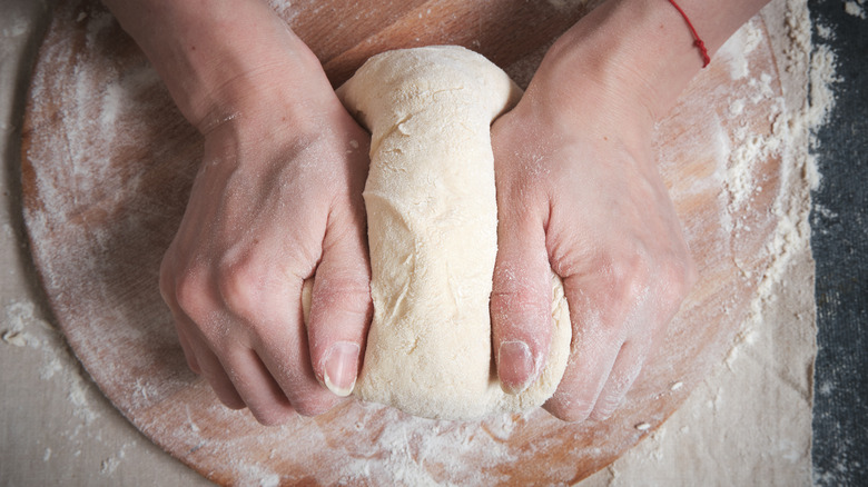 kneading homemade pizza crust