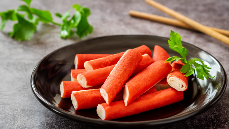 Fresh surimi on a plate with parsley as a garnish.