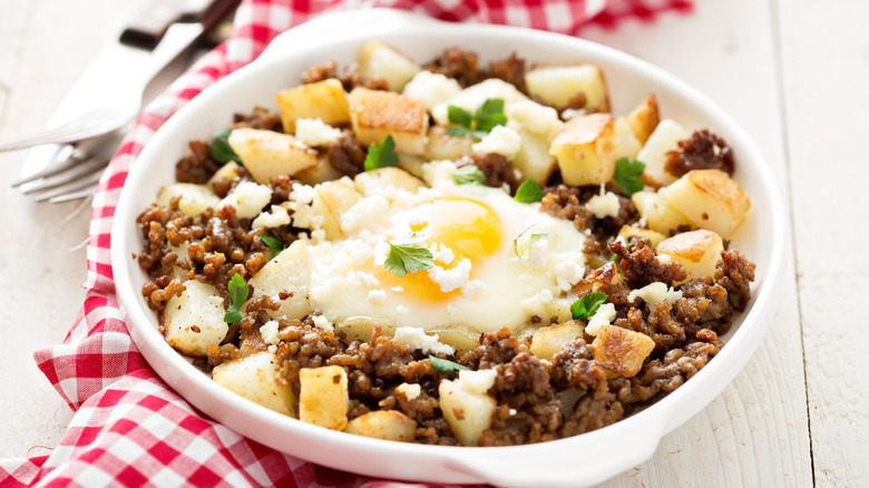 Potatoes, meat, and egg breakfast hash in bowl