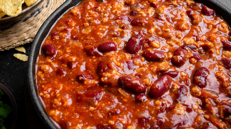 Beef and bean chili in a black bowl
