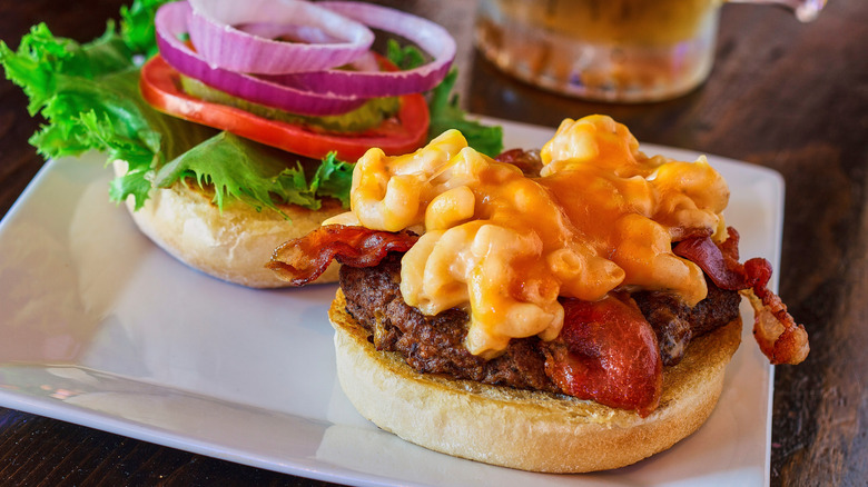 Burger topped with mac and cheese and bacon
