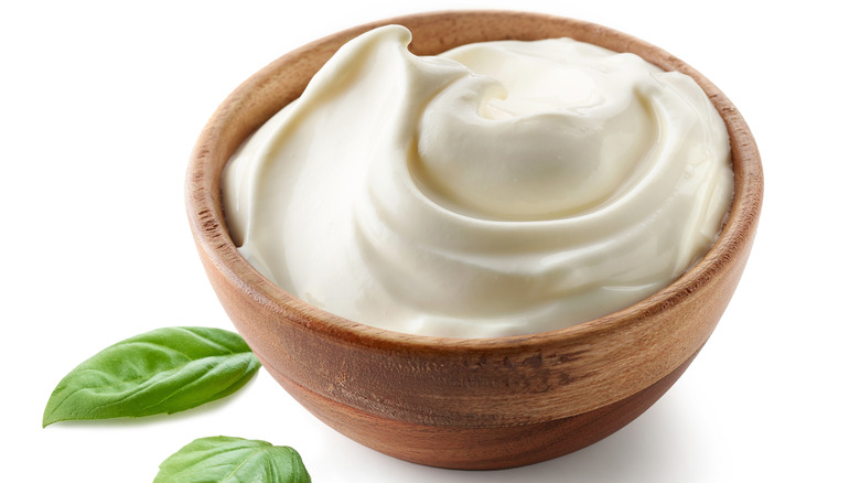 sour cream in wooden bowl