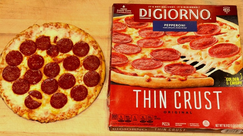 DiGiorno Thin Crust Pepperoni Pizza baked and placed on a wooden cutting board next to the box