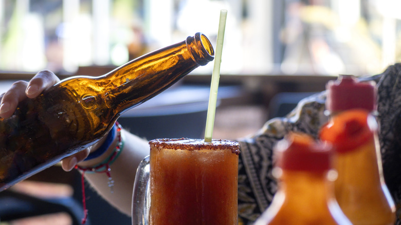 A beer being poured into a michelada